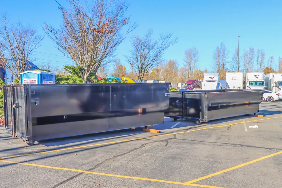 Professional dumpster rental service with roll-off container on residential driveway in Watsonville